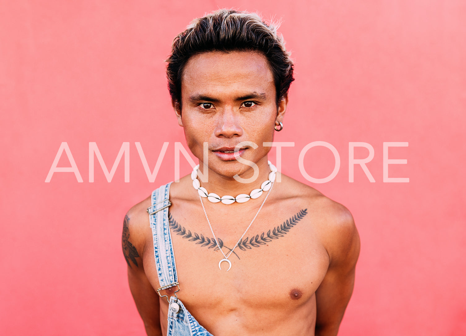 Close up portrait of a young handsome guy with a bare chest looking at camera