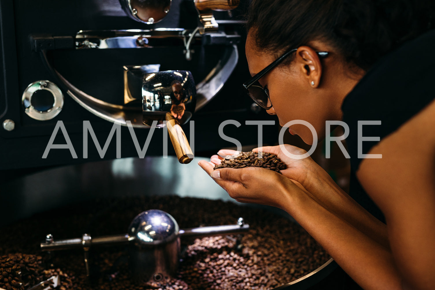 Woman holding coffee beans in two hands, checking quality	