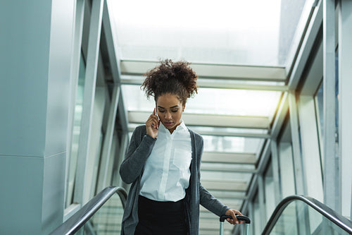 Woman wearing casual clothes, talking on smartphone