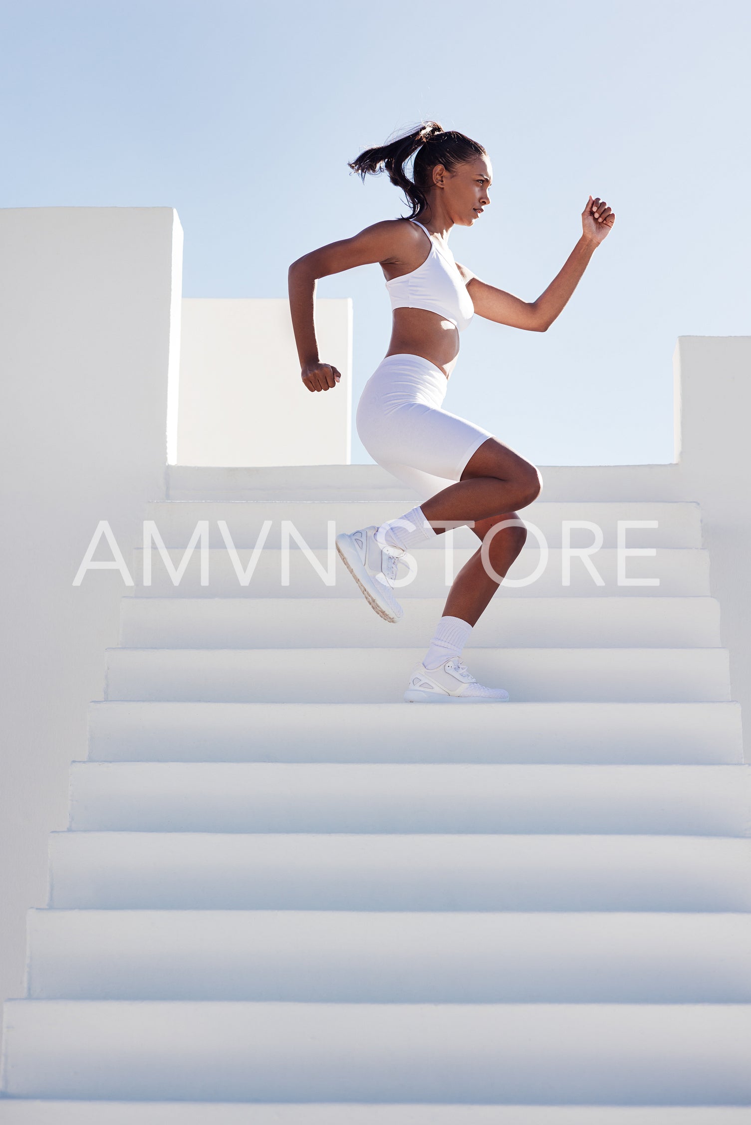 Side view of slim female warming up on stairs. Woman working out on stairs.