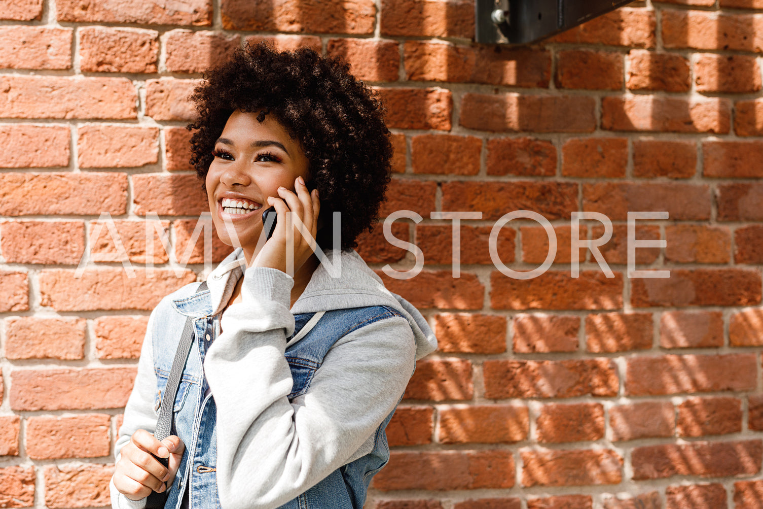 Portrait of a beautiful smiling woman talking on cell phone outdoors	