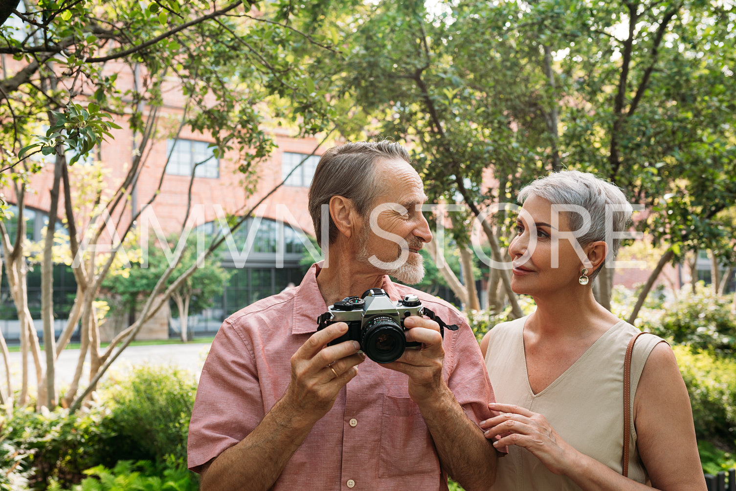 Senior couple looking at each other while standing in the park 