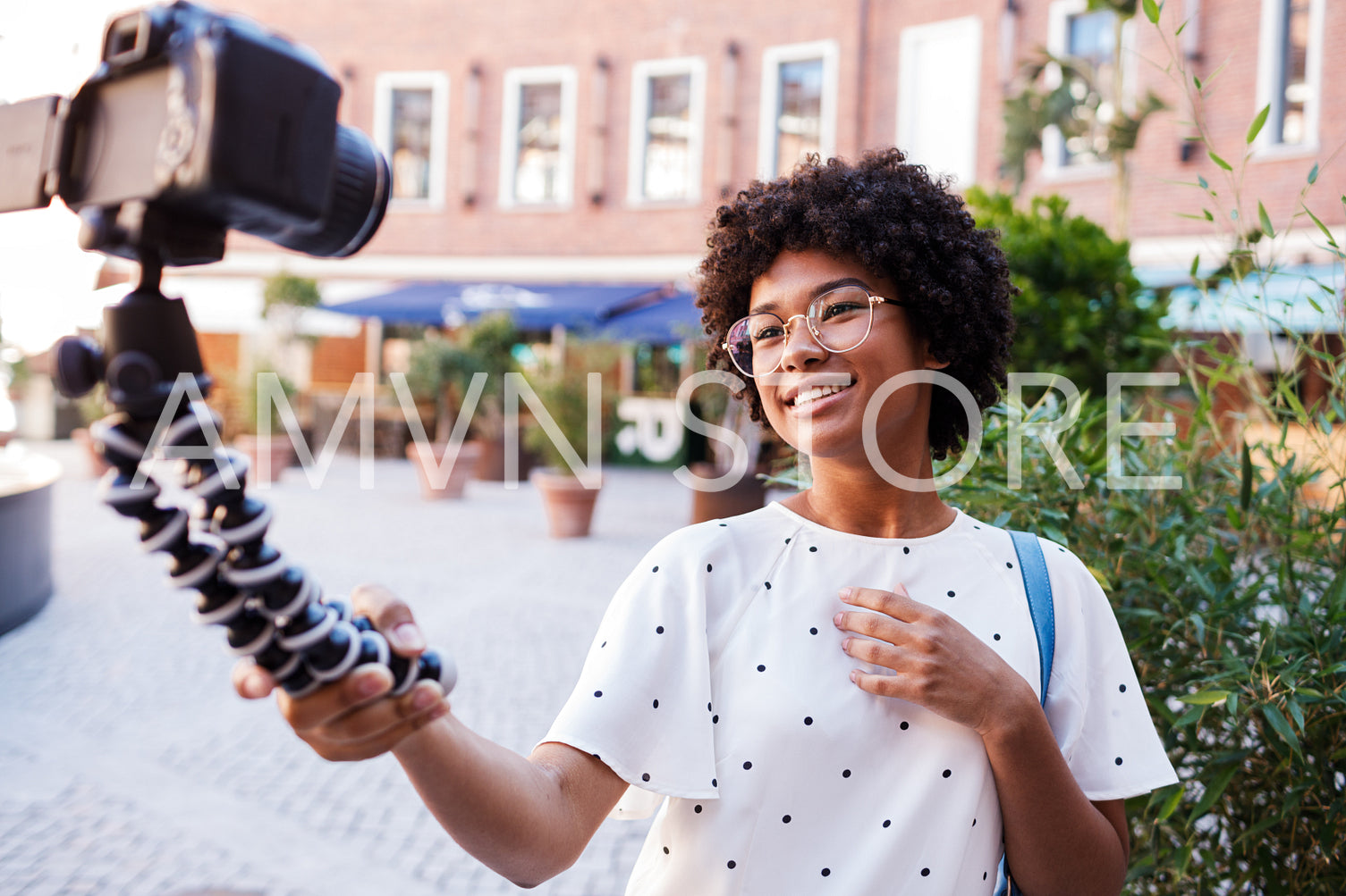 Woman recording a video while walking on street	