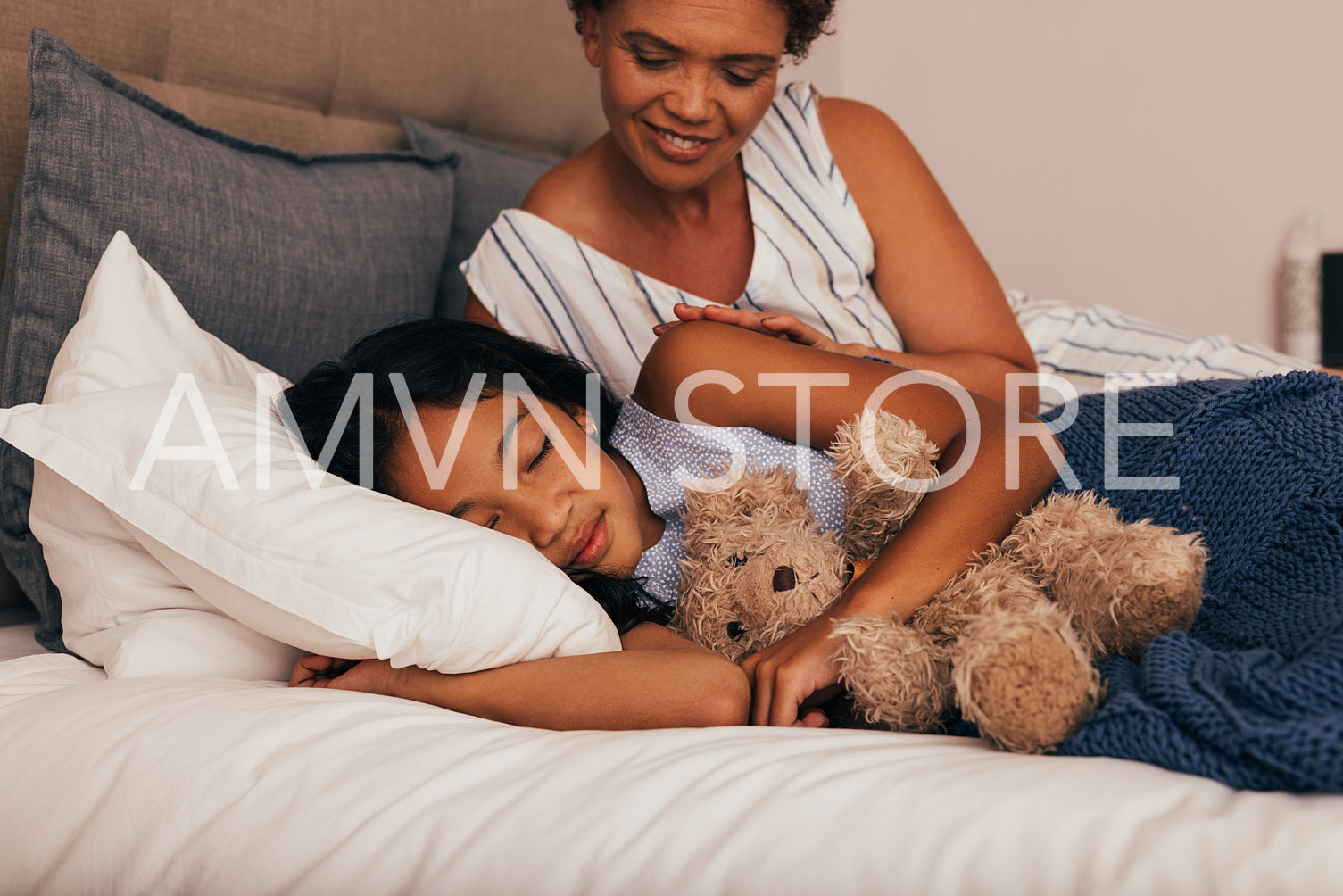 Granny looking at her granddaughter while she sleeping