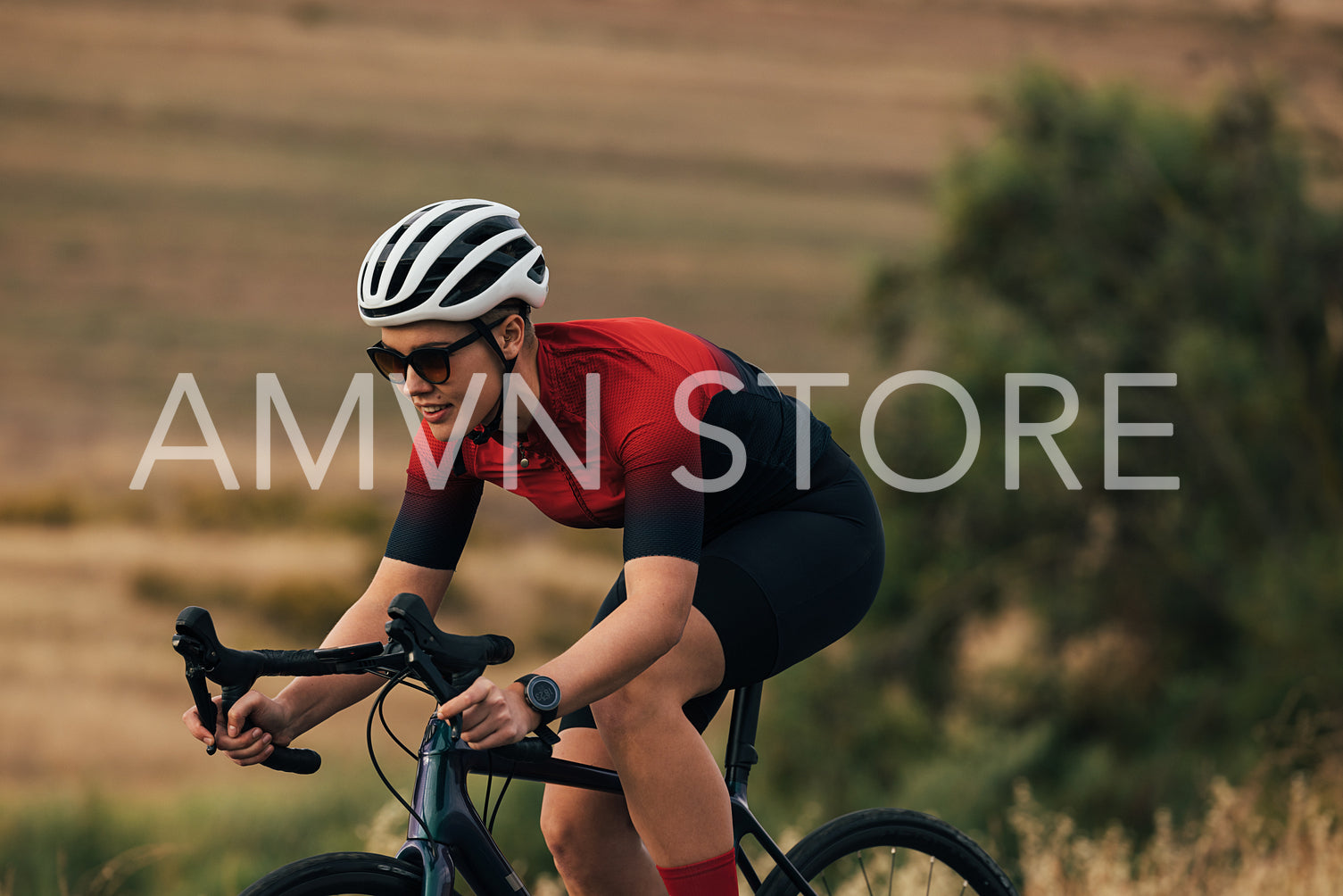 Female cyclist on her professional bicycle during training. Woman bicycle rider on road bike on country road.