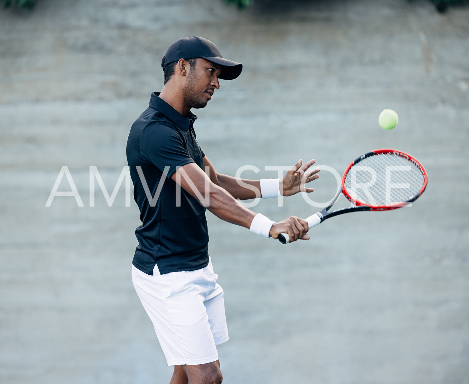 Young tennis player in cap exercising outdoors