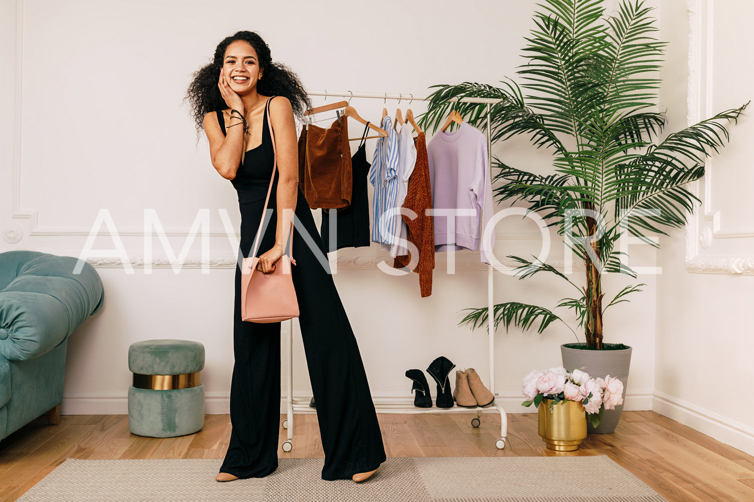 Female fashion vlogger posing in front of a clothes rack	
