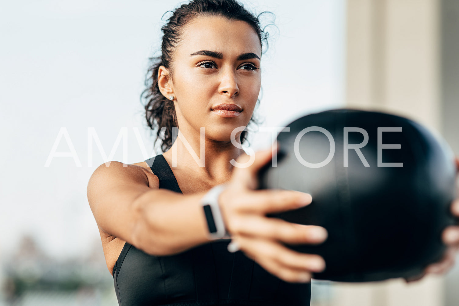 Young muscular woman exercising with a medicine ball	