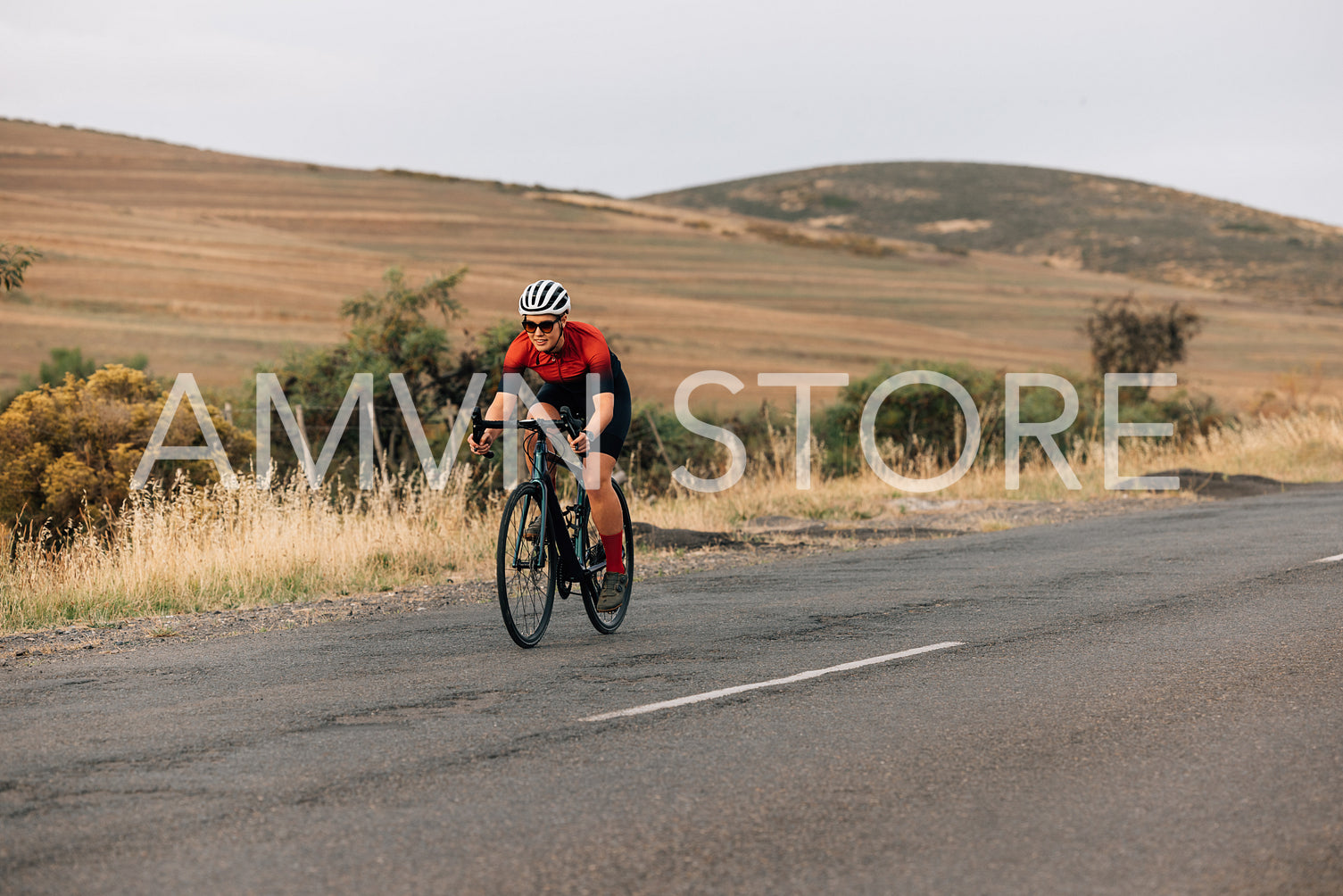 Road bike female cyclist riding on pro bike outdoors. ˜Woman practicing on bicycle on empty road.