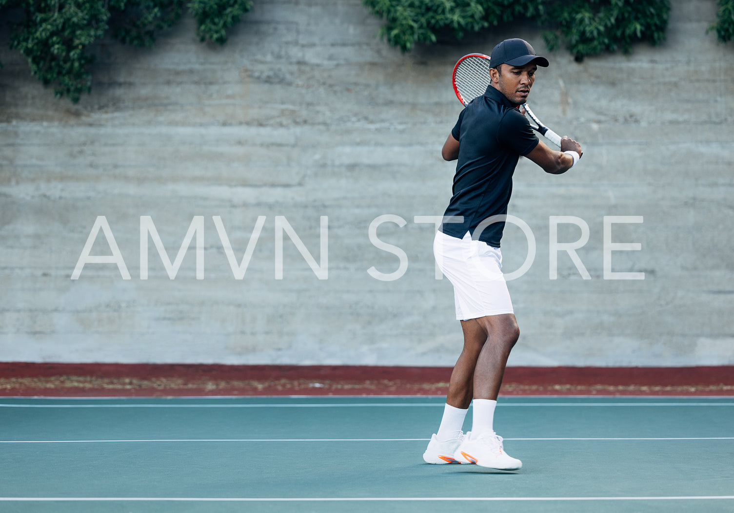 Full length of  a male tennis player standing on a hard court during a match