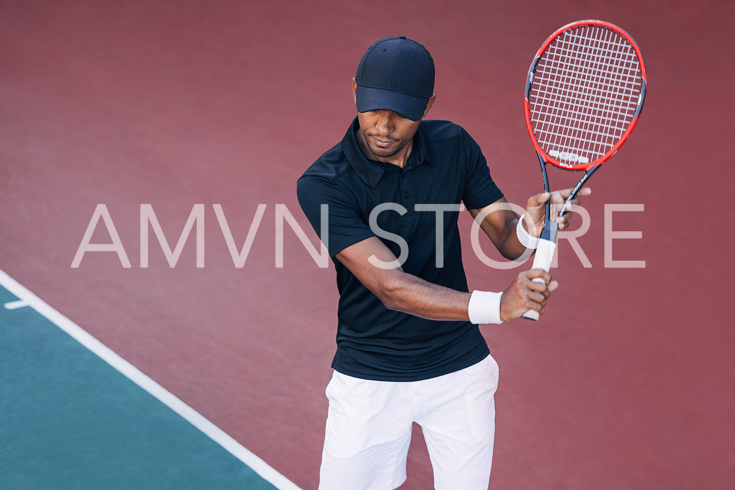 Professional tennis player in a cap holding a racket on a hard court