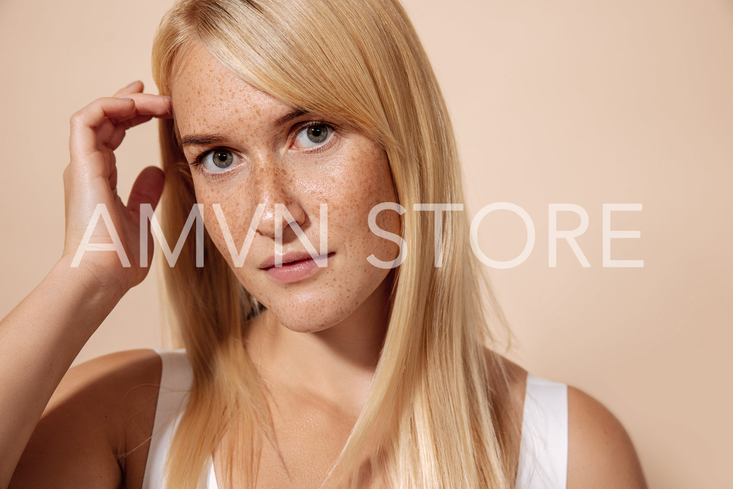 Close up portrait of a young beautiful woman with freckles posin