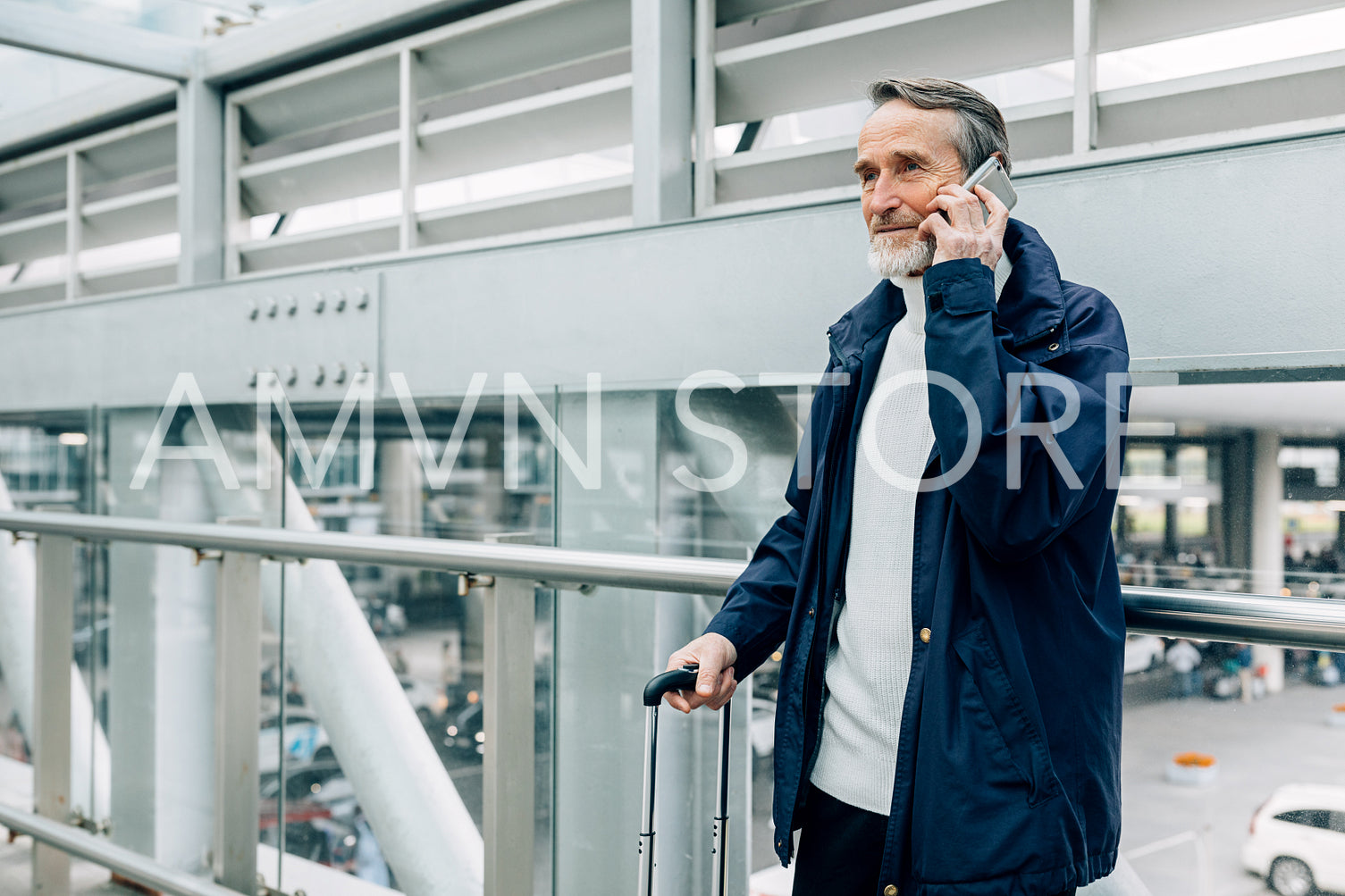 Senior tourist standing in airport terminal and talking on mobile phone	