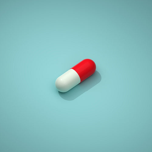 Pill with a white and red part on a blue background. Capsule lying on a blue background, 3d render, 3d illustration