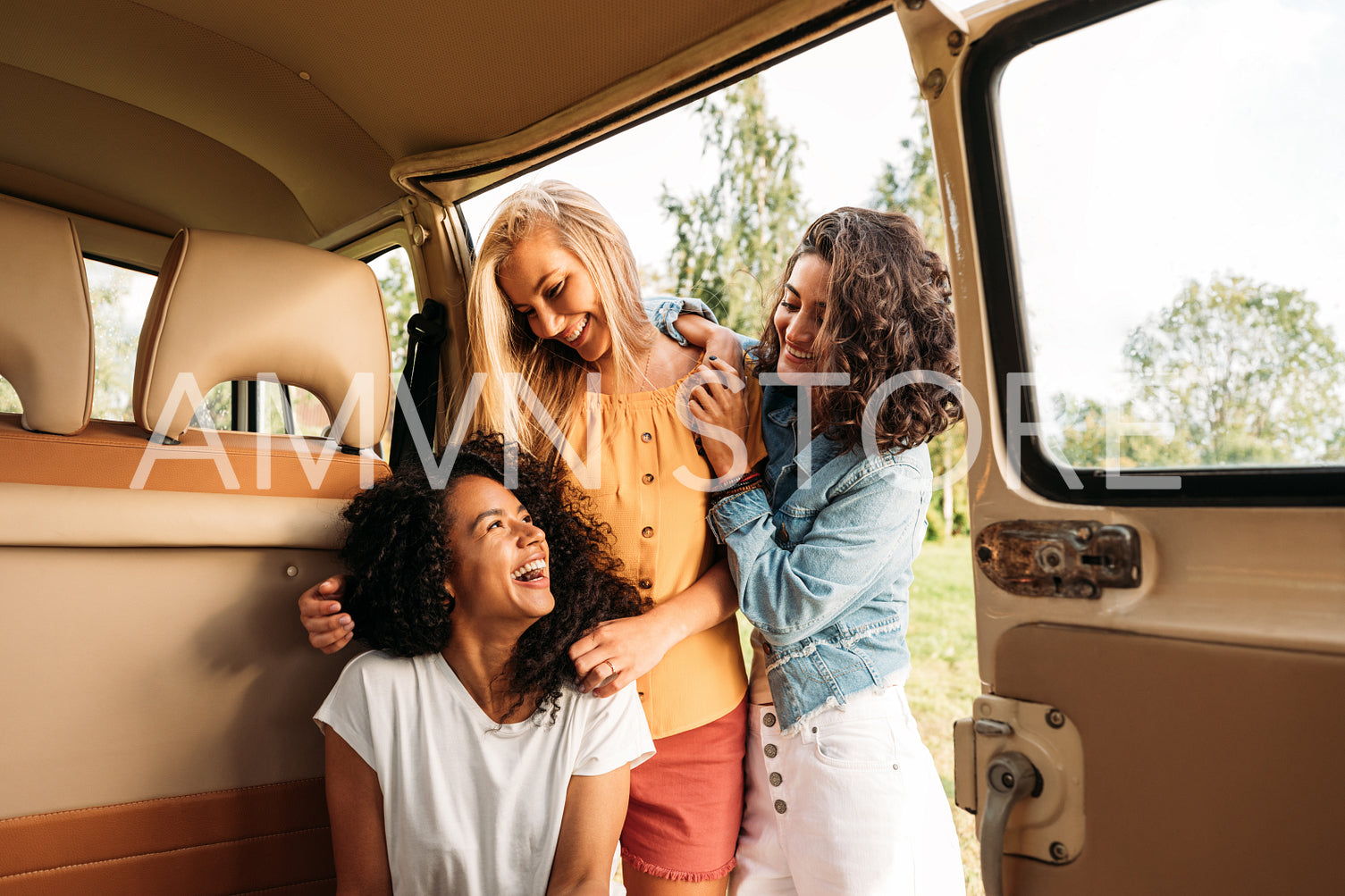 Three cheerful women having fun during road trip