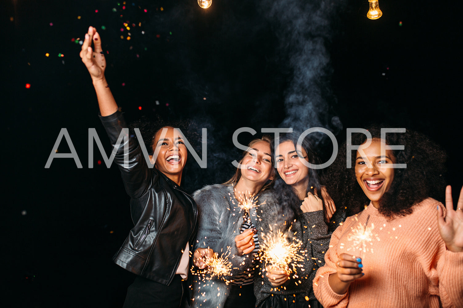 Four young females hanging out at night. Women celebrate with confetti and sparklers.