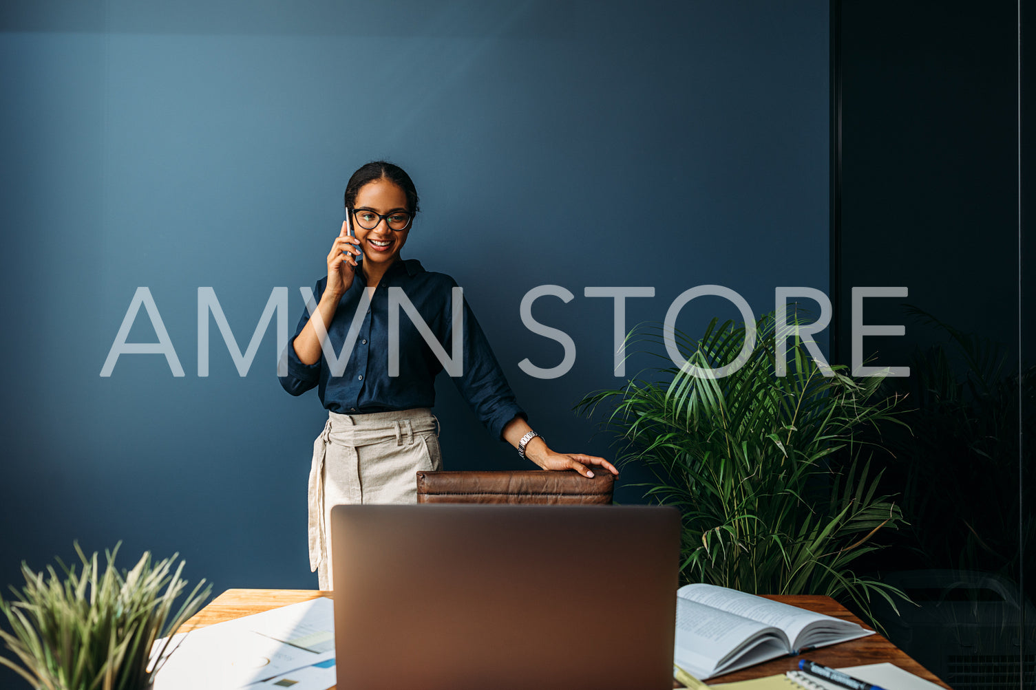 Female entrepreneur leaning to a chair in the home office while looking on a laptop screen	