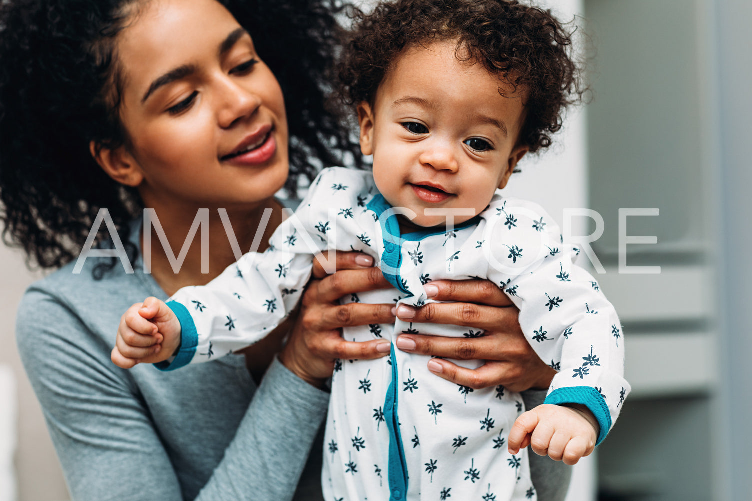 Woman holding her toddler son. Portrait of a young mom with son.	