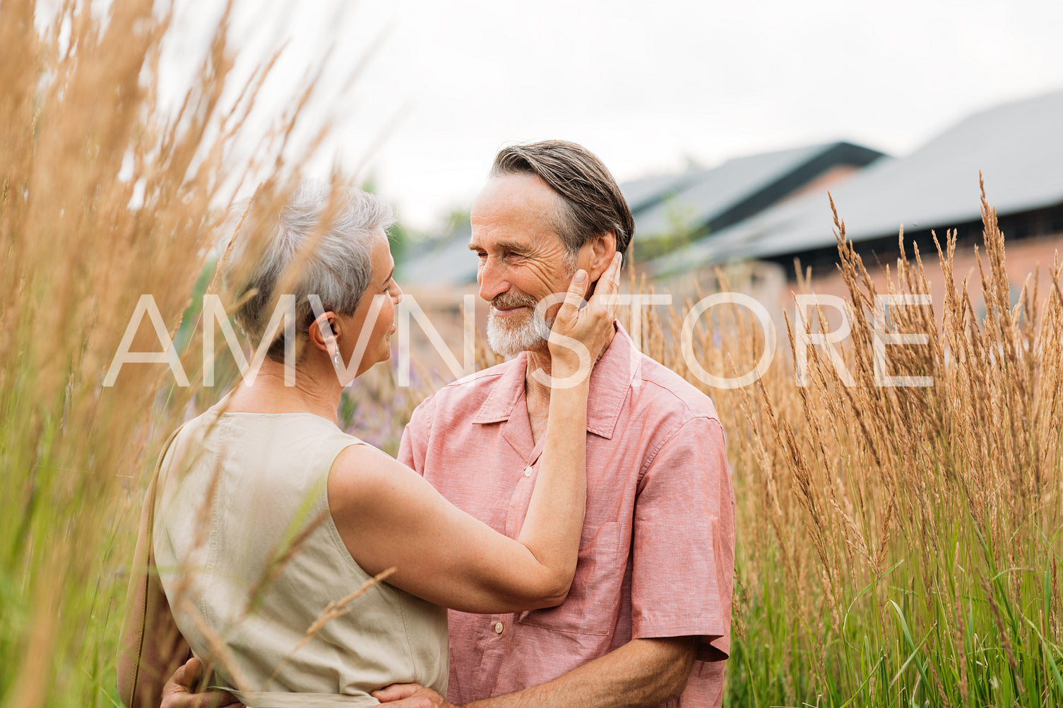 Aged romantic couple on a wheat field. Mature man and woman on a wheat field.