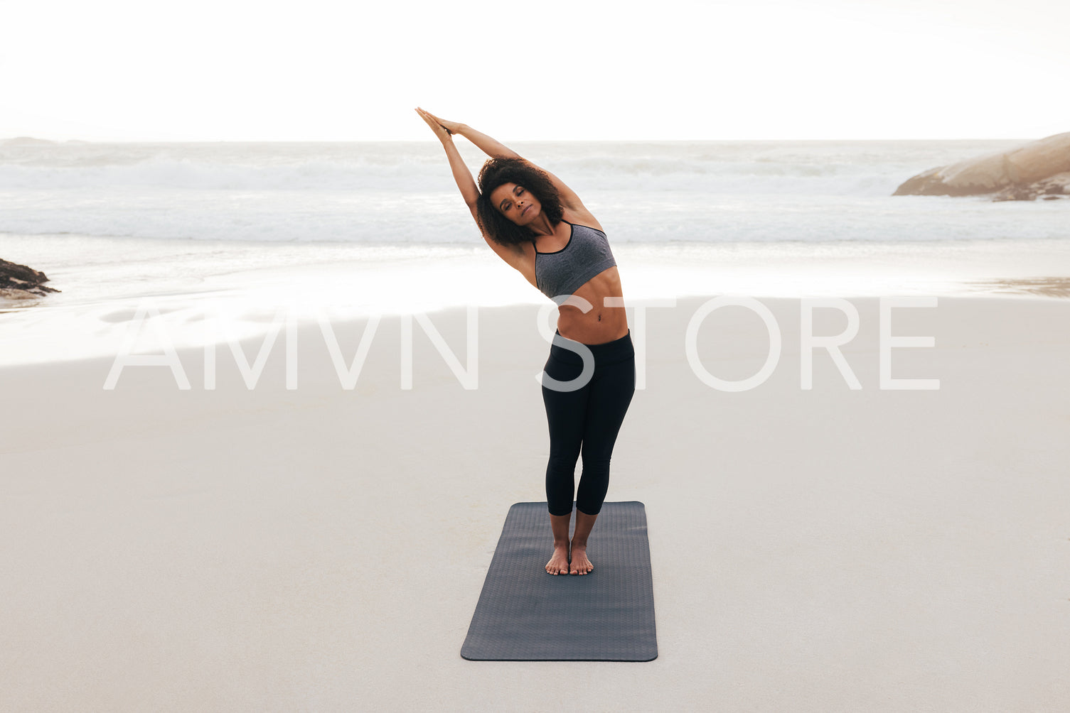 Young woman practicing yoga at sunset. Fitness female doing side