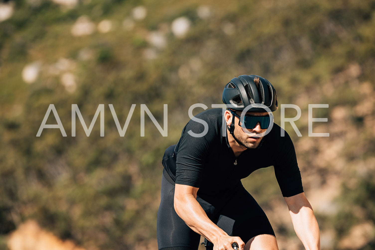 Male cyclist in black sportswear during training