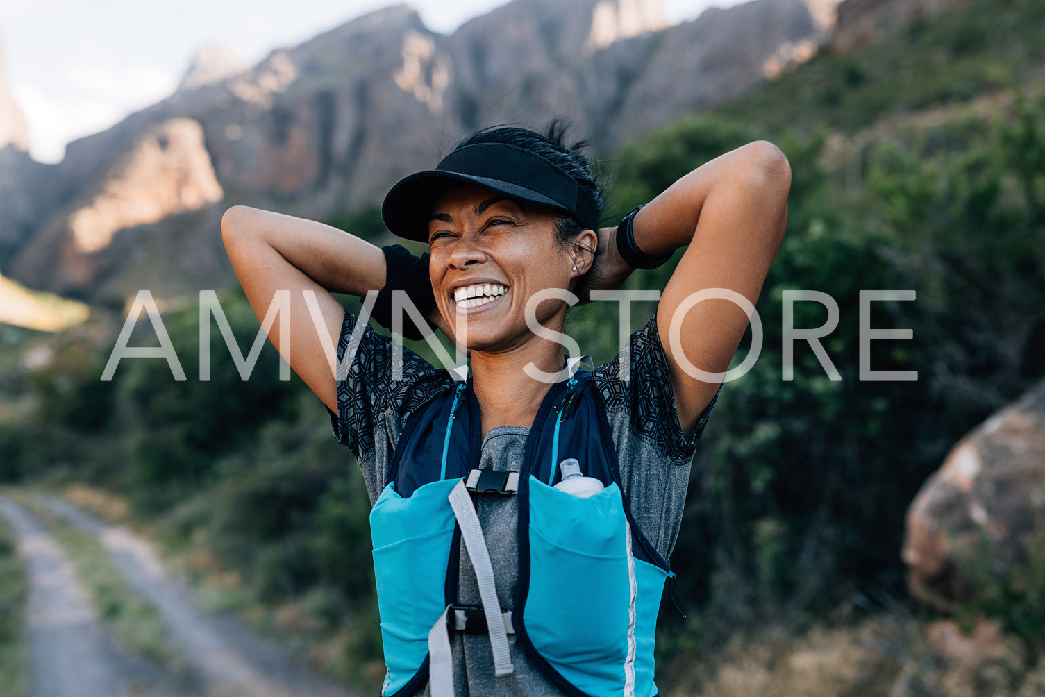 Laughing woman hiker taking a break during her hike