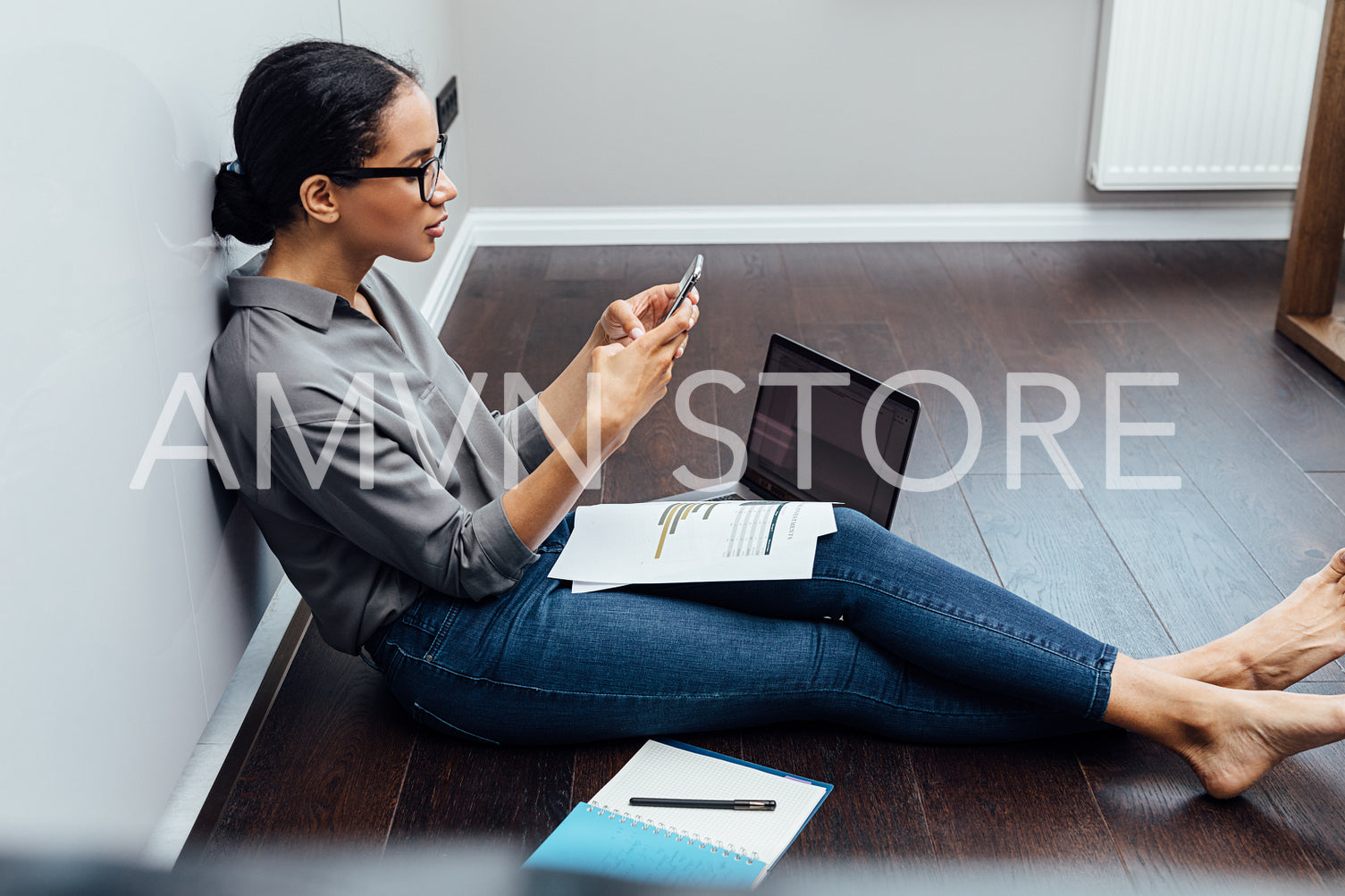 Businesswoman using smartphone while sitting in living room	