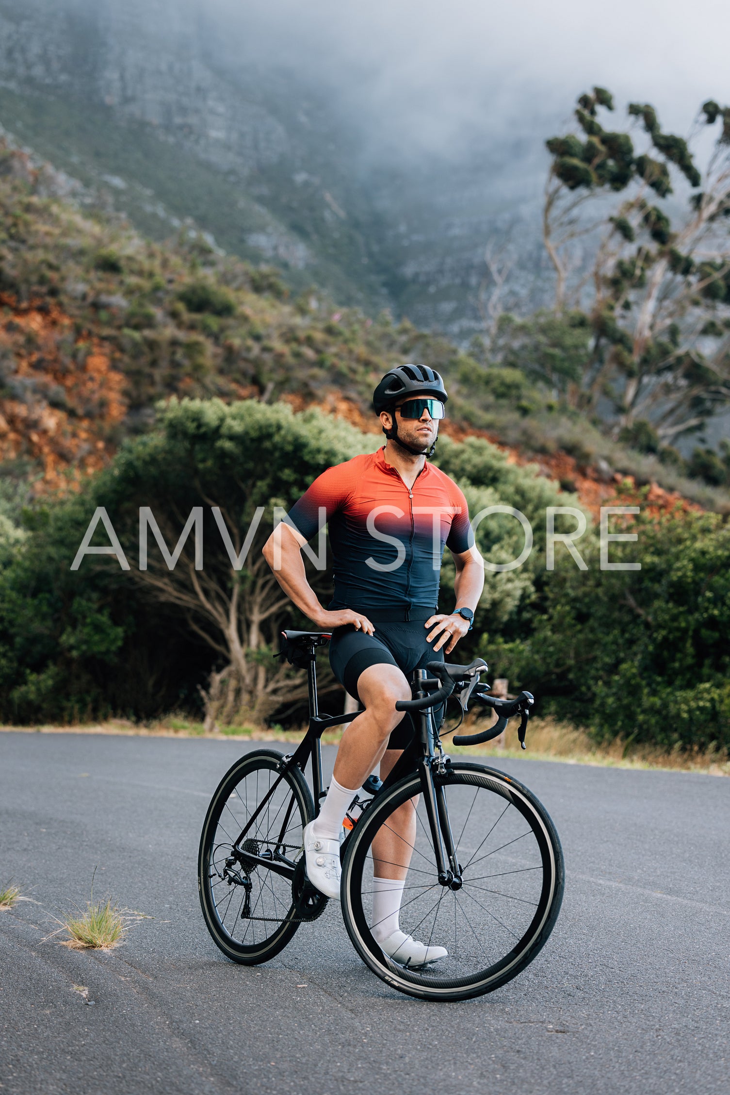 Full length of a professional cyclist. Male road bike rider taking a break.