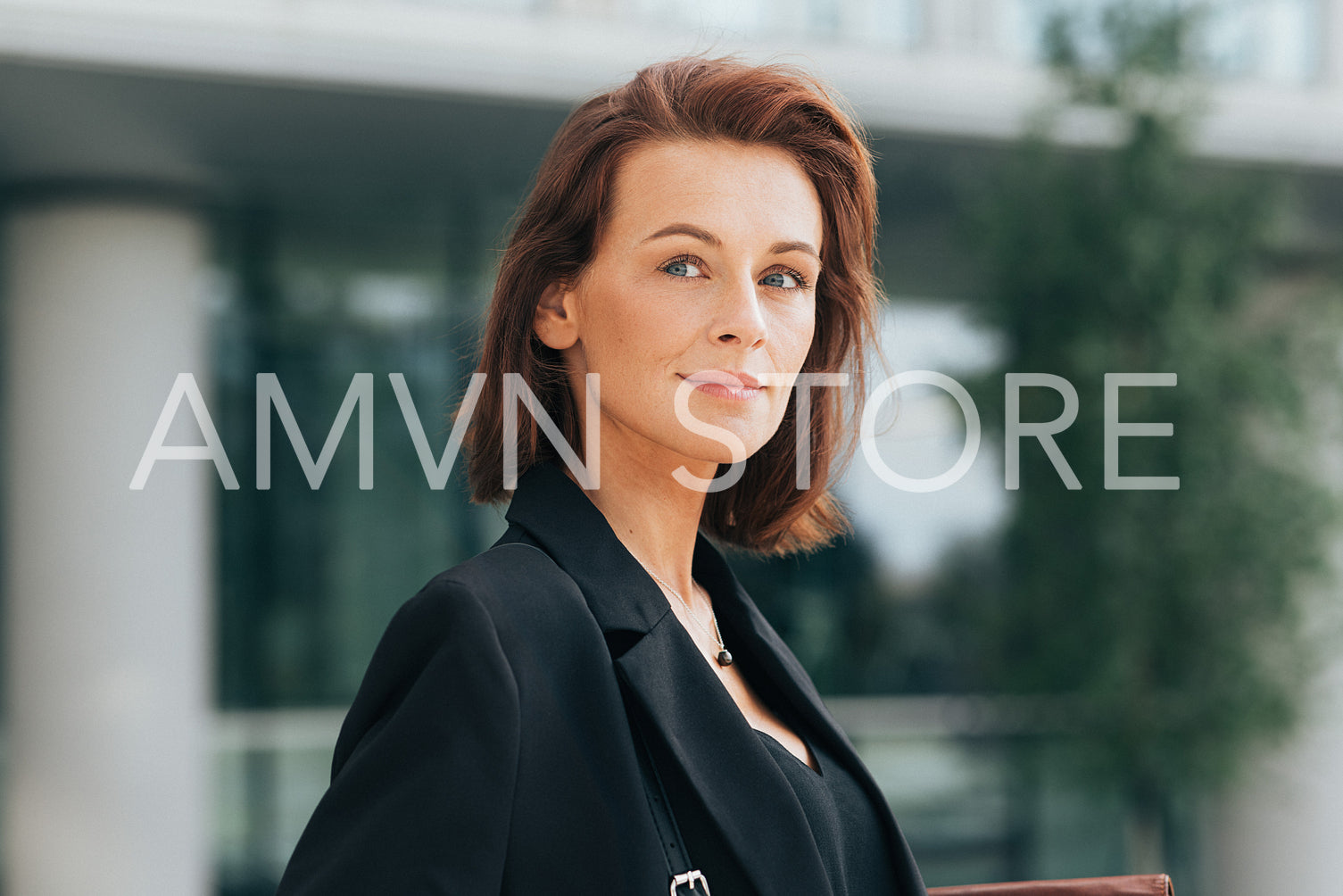 Portrait of a middle-aged businesswoman with ginger hair looking away