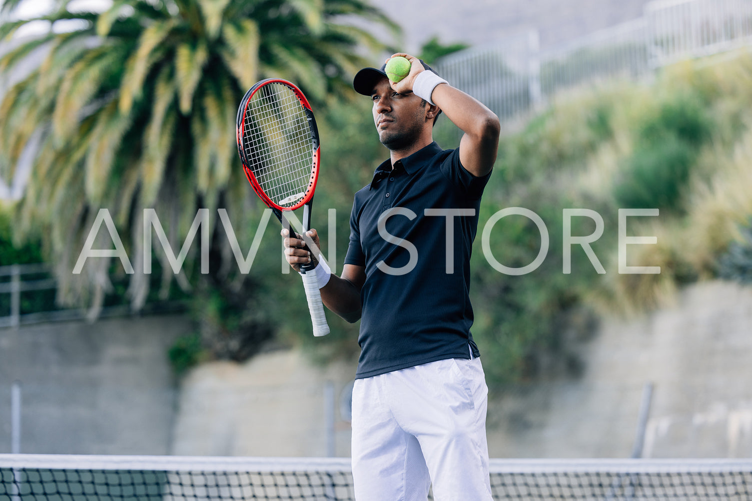 Young man with a tennis racket and tennis ball relaxing during a match