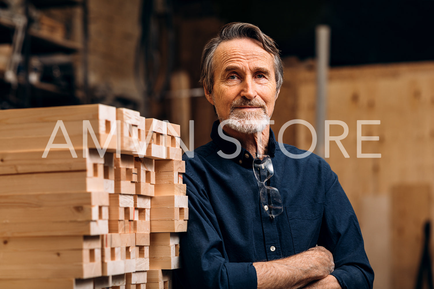 Portrait of confident senior male carpenter standing in his workshop	