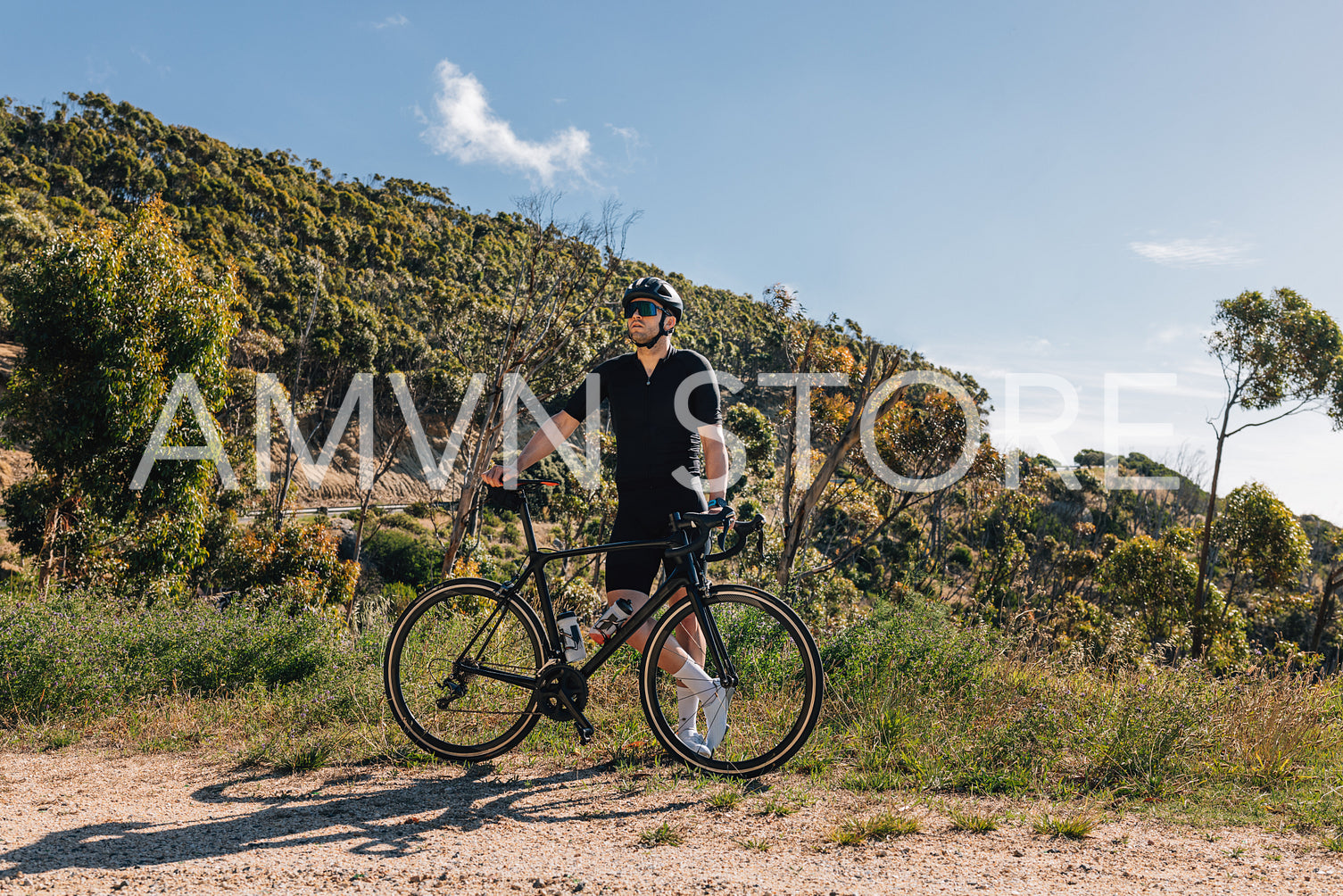 Young male with bicycle relaxing during training enjoying the view