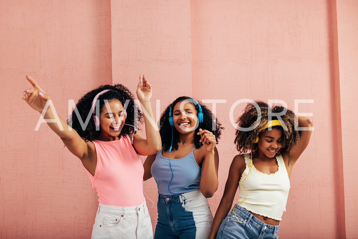 Happy women listening to music and dancing together