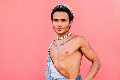 Portrait of a young male in overalls looking at camera