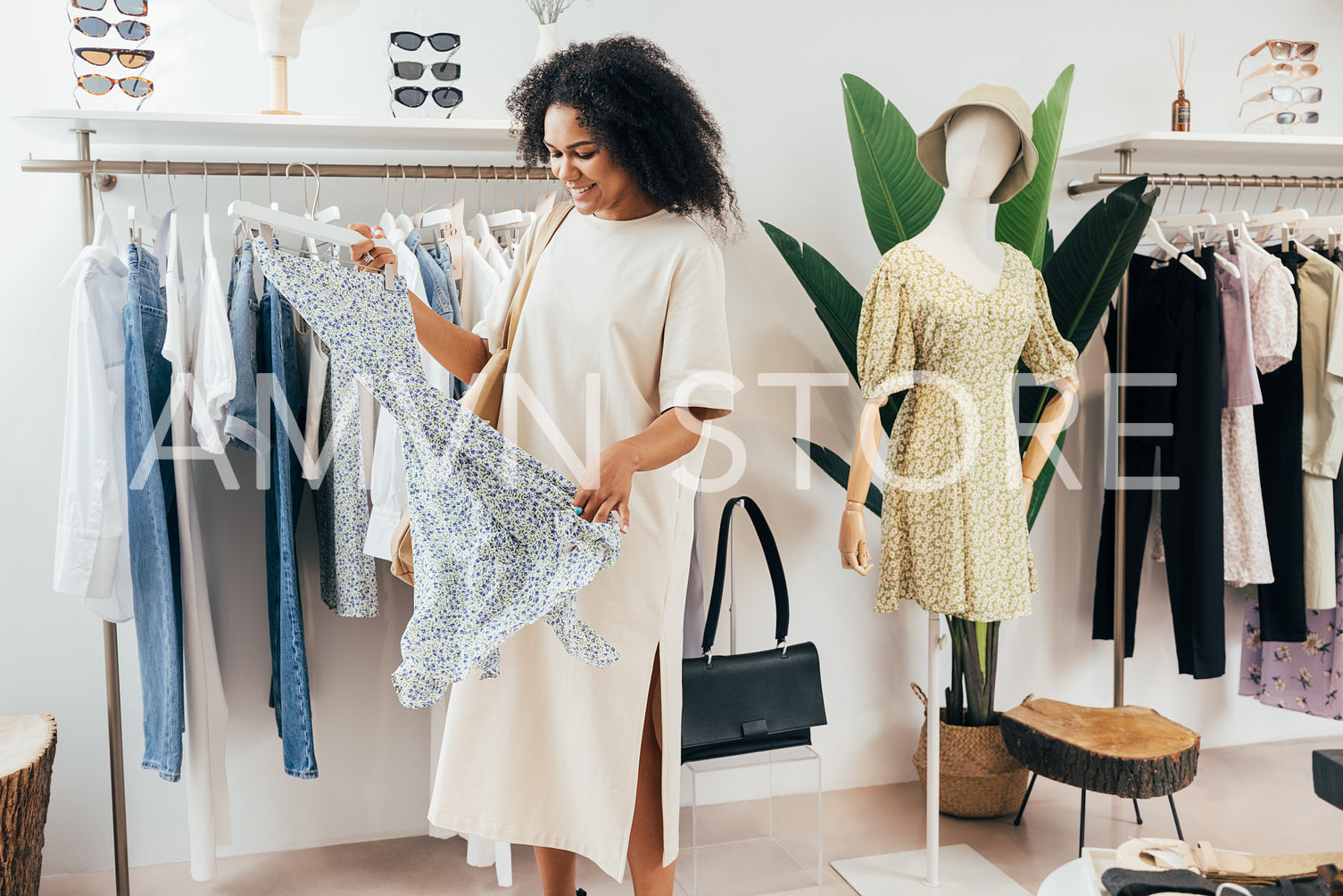 Female customer choosing dress in a local clothing store