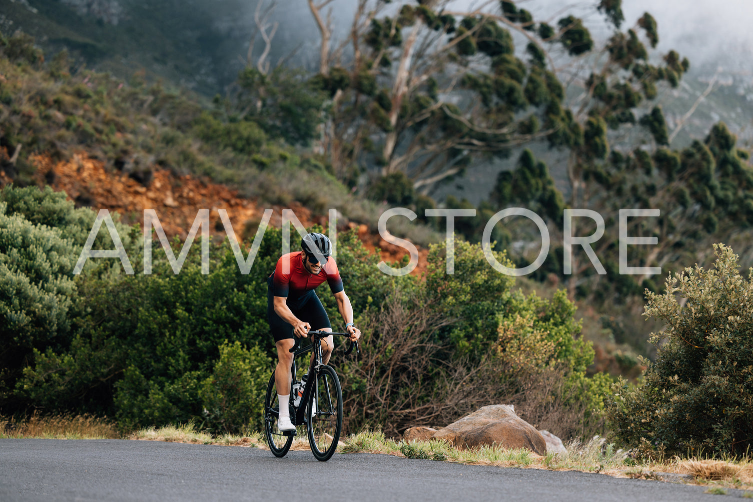 Young male cyclist practicing in wild terrain. Professional triathlete riding road bike.