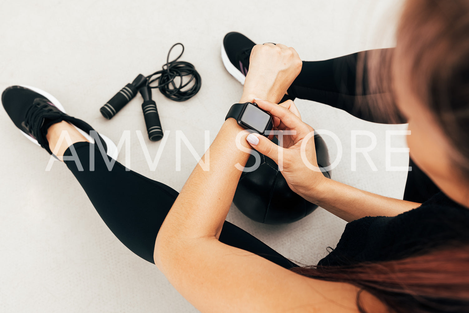 Cropped shot of unrecognizable sportswoman looking at smartwatch outdoors