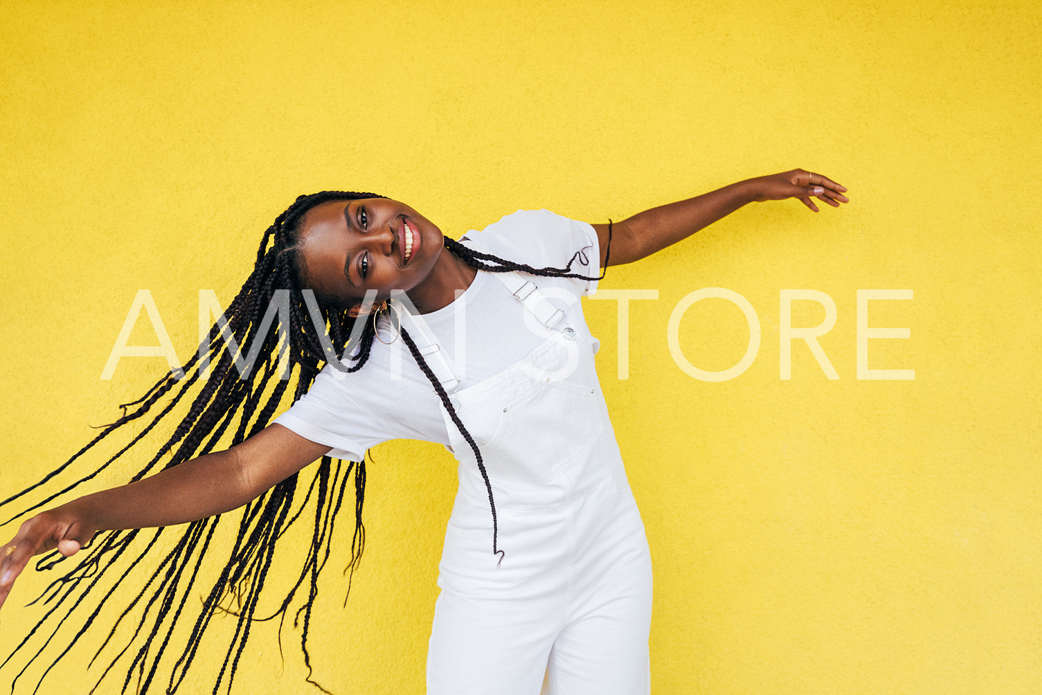 Portrait of a happy woman in casuals with braids enjoying good mood outdoors