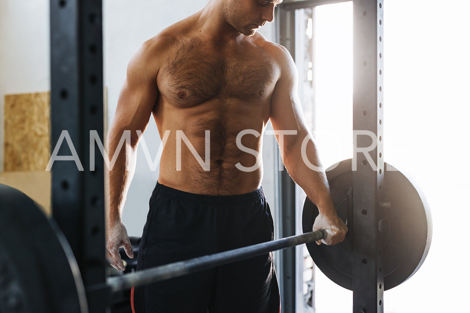 Unrecognizable sportsman holding a barbell, getting ready to lift weight	