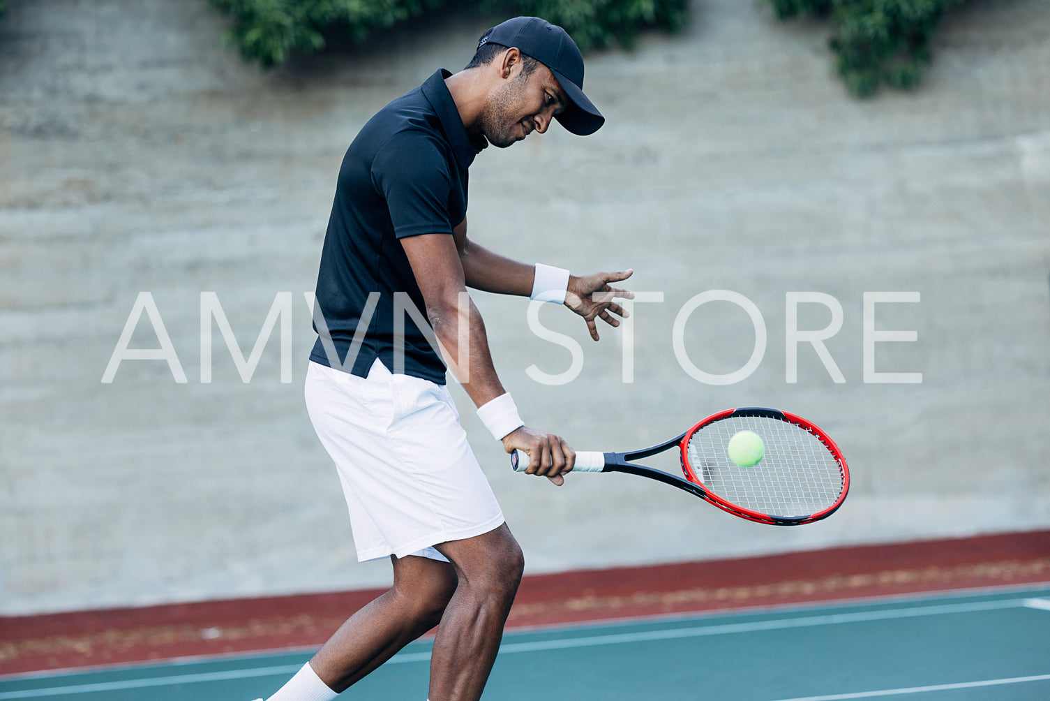 Young man playing tennis outdoors. Tennis player hitting a ball.