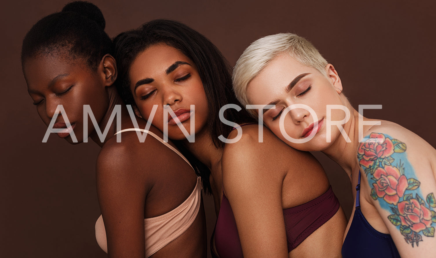 Portrait of three diverse women in lingerie standing together with eyes closed against a brown background