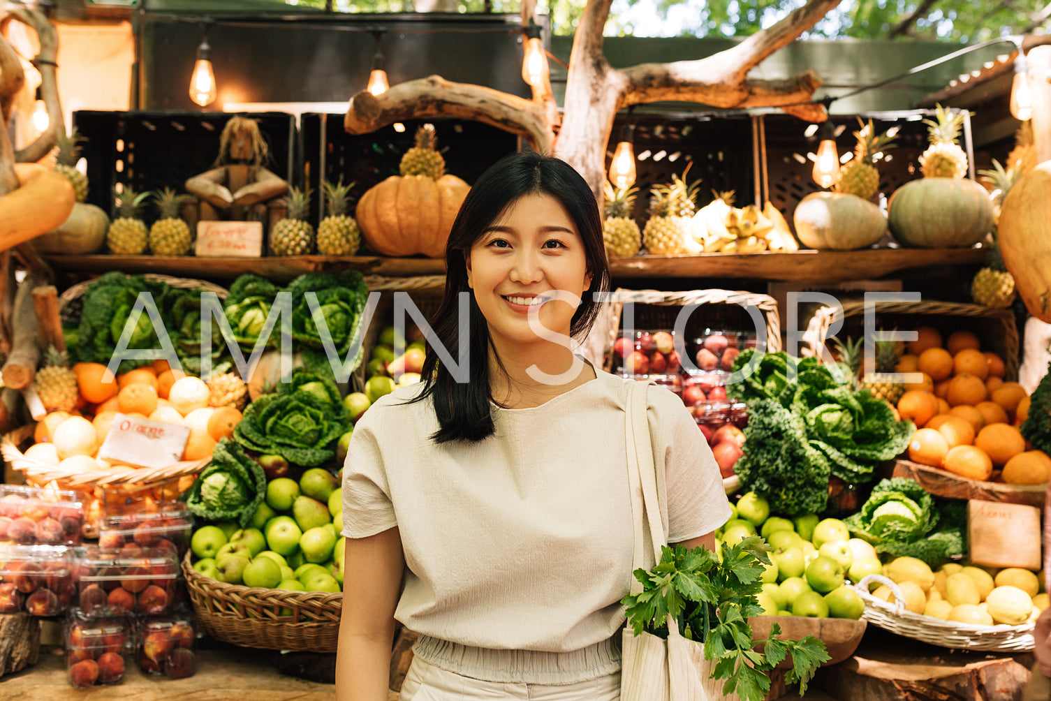 Portrait of a young Asian woman while standing at an outdoor market