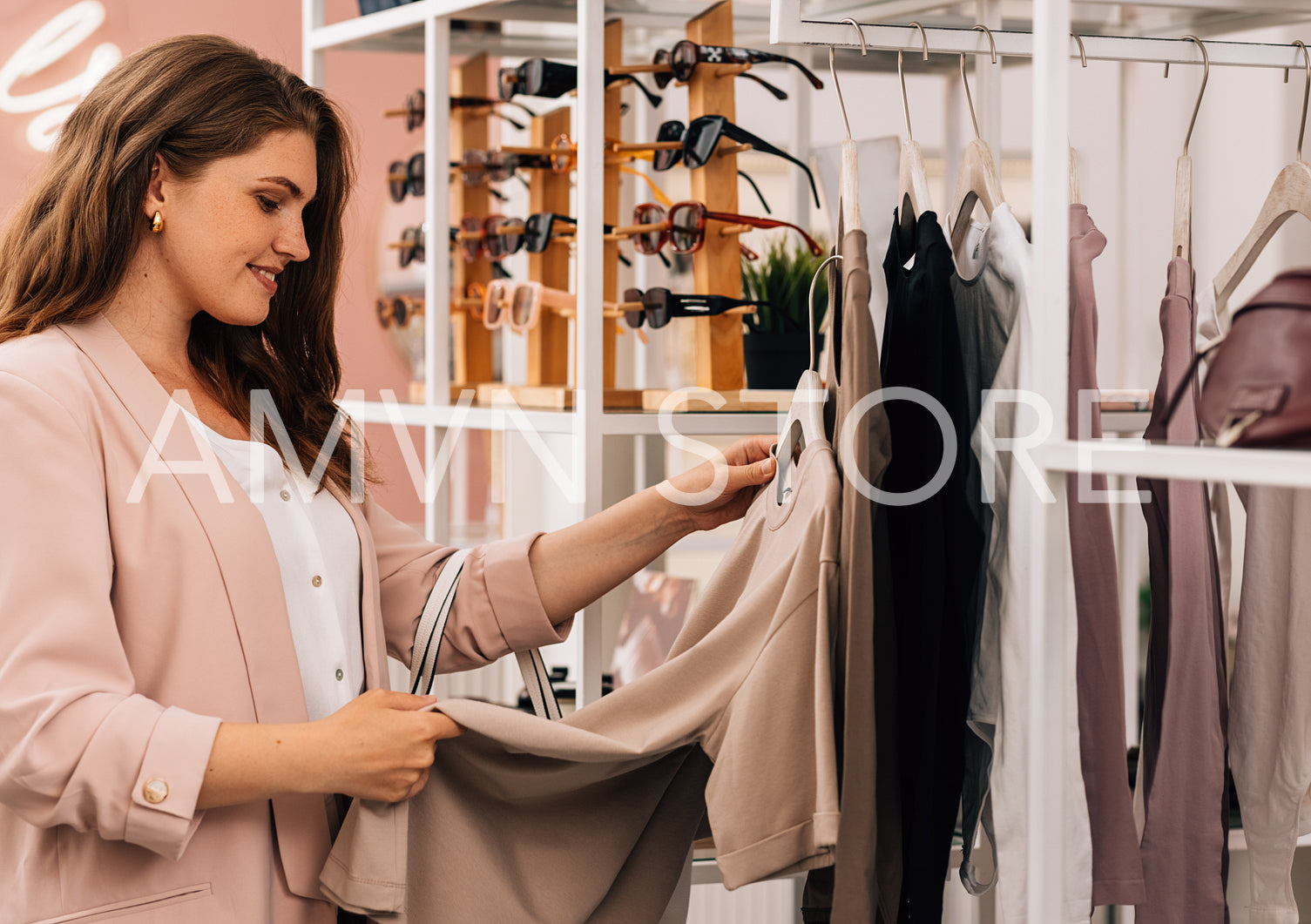 Side view of a smiling plus size woman shopping in a small cloth