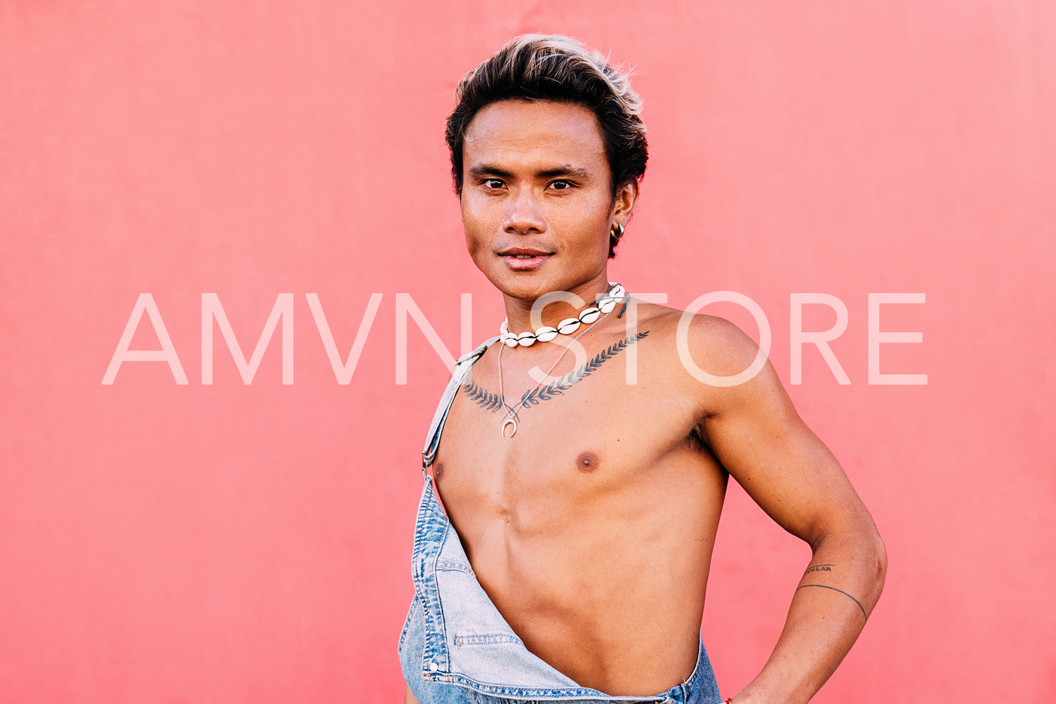 Portrait of a young male in overalls looking at camera