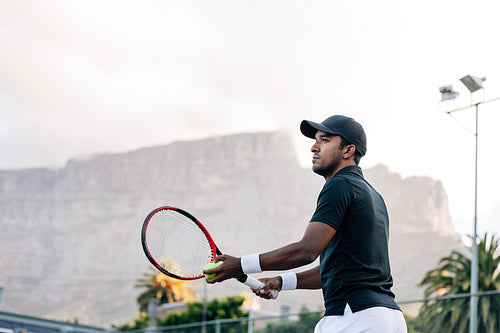 Tennis player preparing to serve a tennis ball