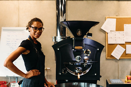 Small business owner standing in her coffee roasting shop