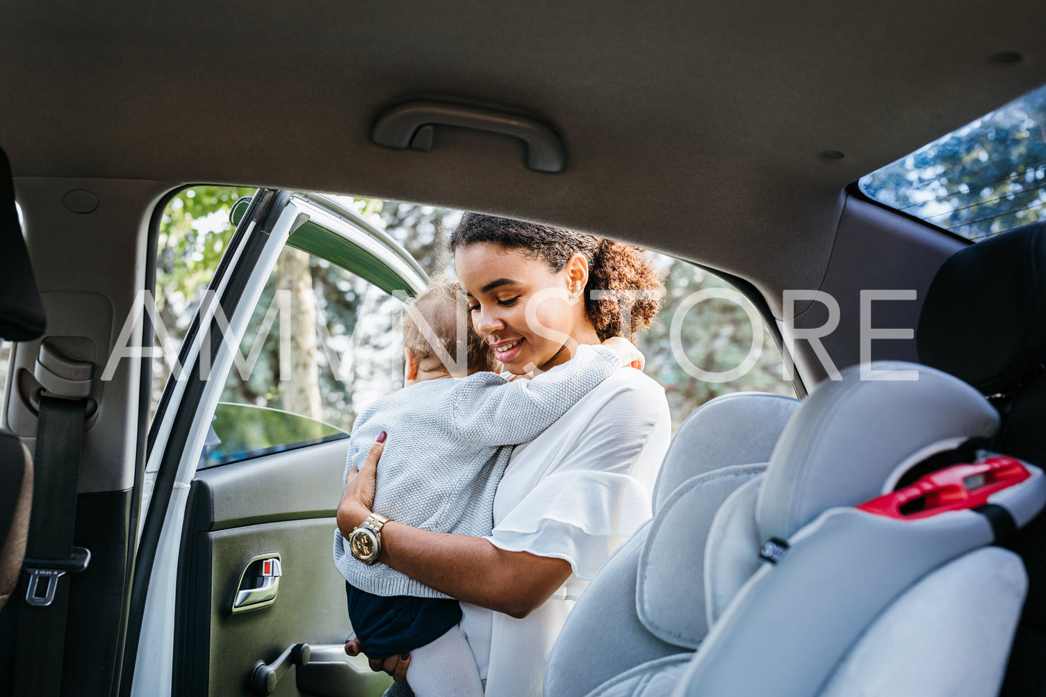 Mother holds daughter prepare to sit her on a car seat	