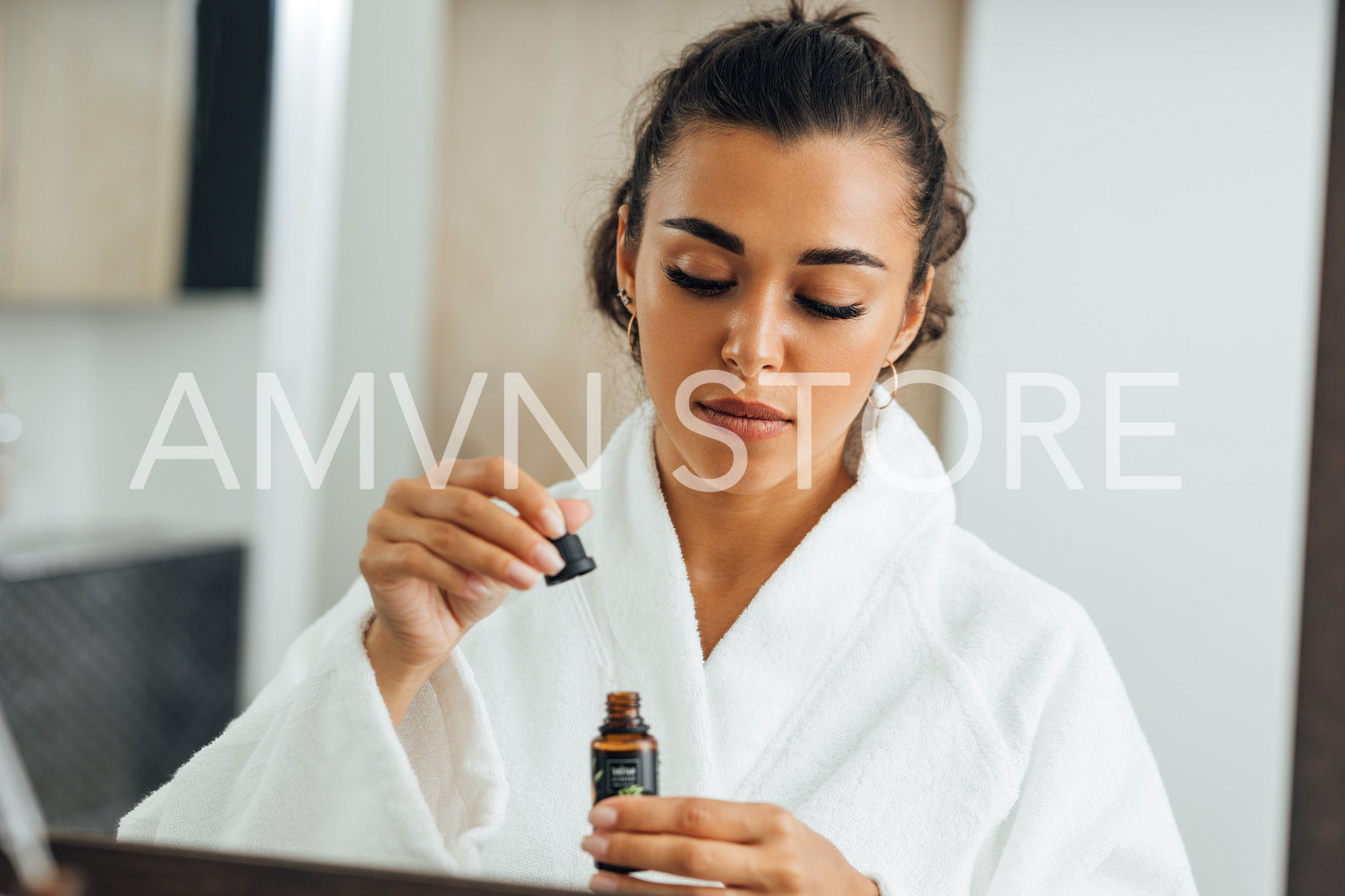 Brunette woman in bathroom holding dropped with hyaluronic acid	