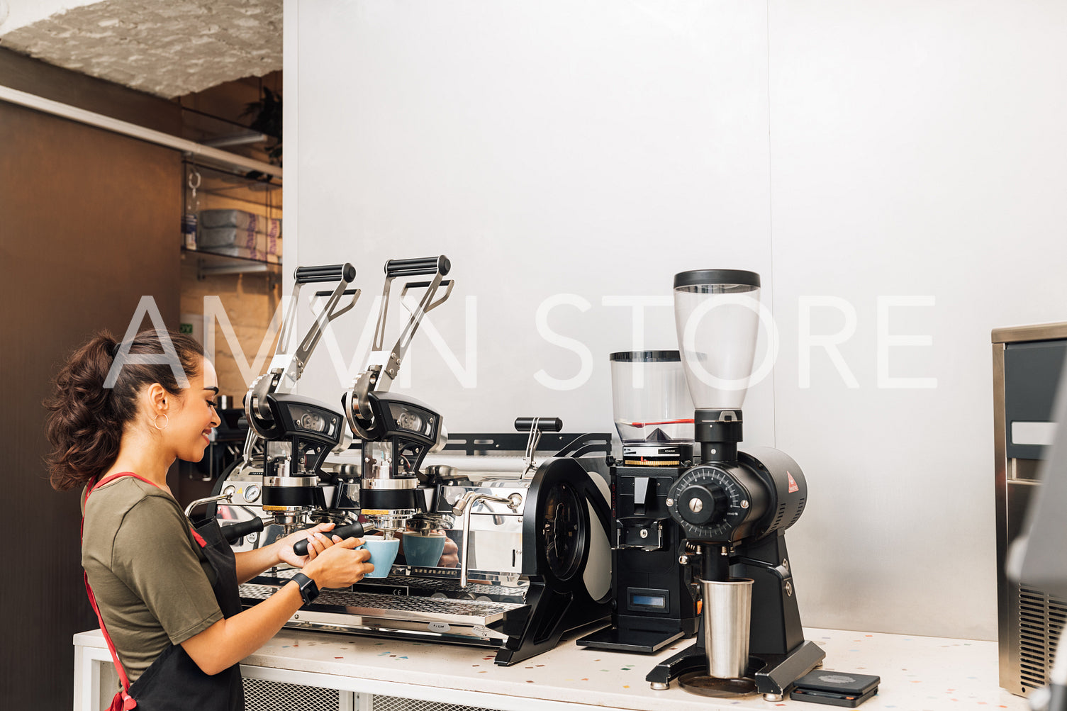 Female barista standing by coffee maker while working in cafe. Woman in apron preparing coffee.	