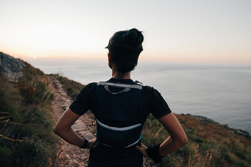 Woman in sportswear looking on path on a hill